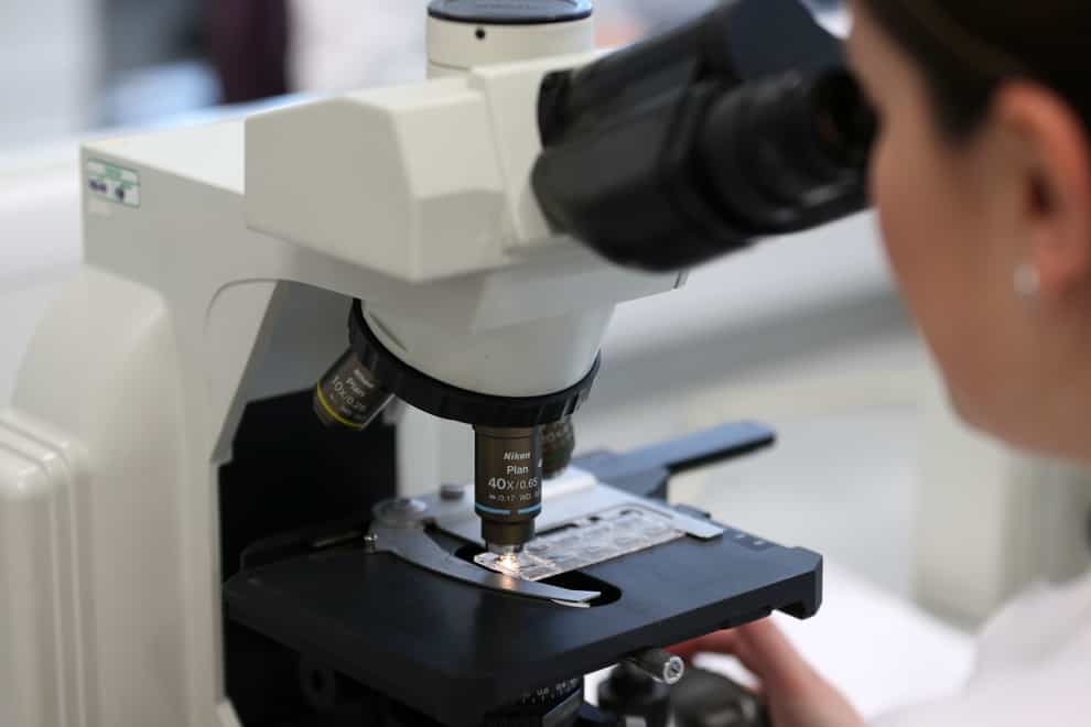 Woman using microscope