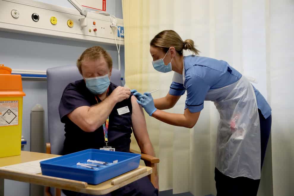 Deputy charge nurse Katie McIntosh administers the first of two Pfizer/BioNTech Covid-19 vaccine jabs to Andrew Mencnarowski at the Western General Hospital in Edinburgh