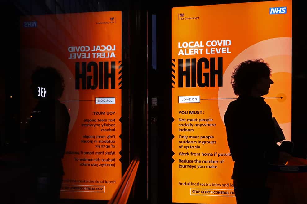 An Covid high alert level sign on a bus shelter in central London (Yui Mok/PA)