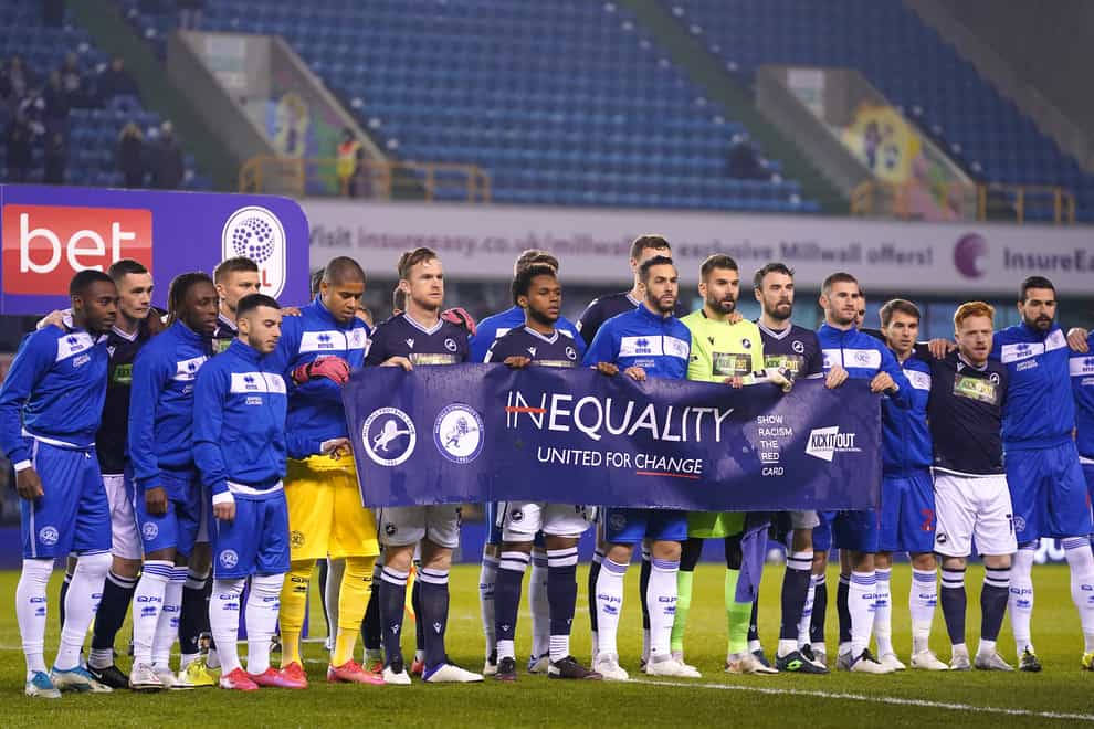 Millwall and QPR players held up an anti-racism banner before their Championship game at The Den