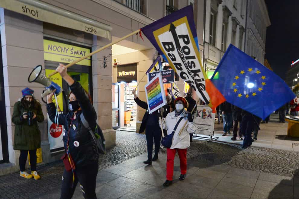 Protesters carry an EU flag at an anti-government protest in Warsaw