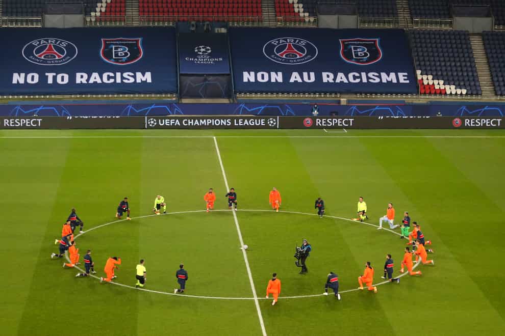 Paris St Germain and Istanbul Basaksehir kneel to show support for the fight against racism