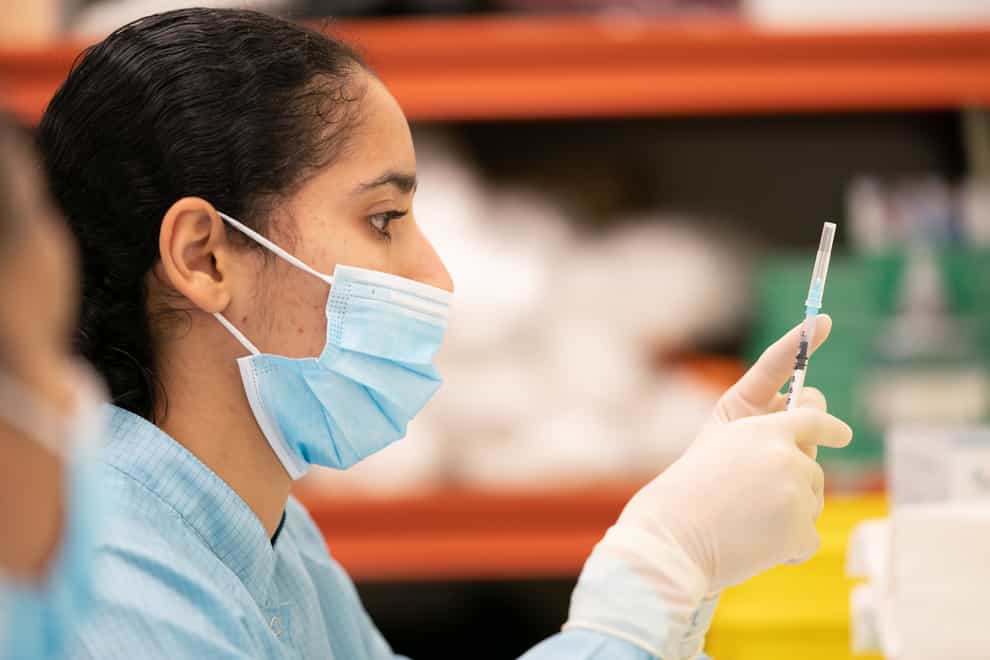 A member of medical staff prepares a Pfizer-BioNTech Covid-19 vaccine at The Vaccination Hub at Croydon University Hospital
