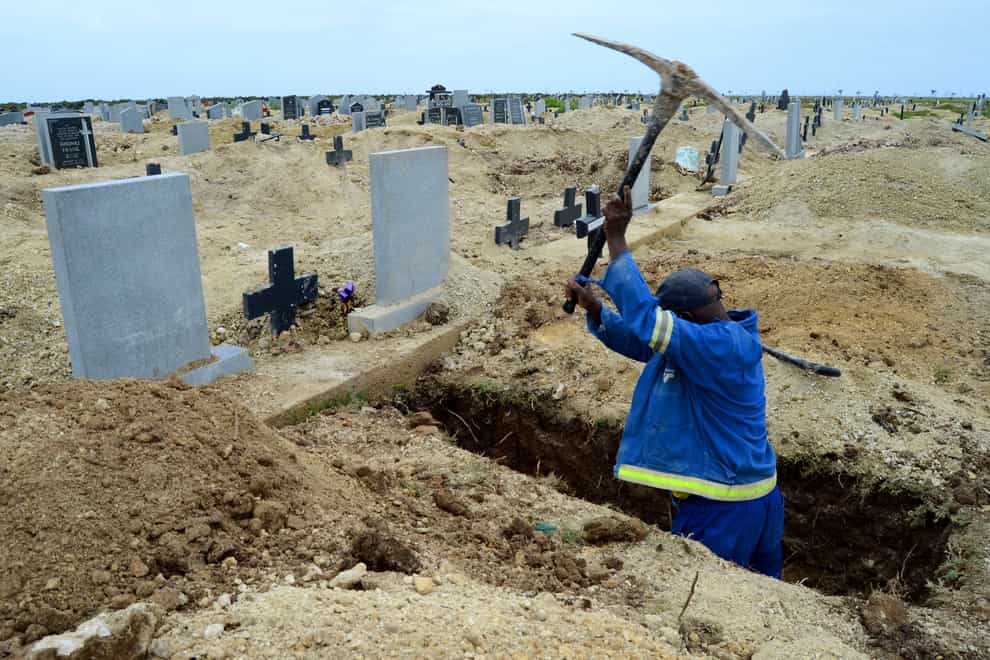 A grave digger prepares graves in Port Elizabeth amid a second wave of coronavirus in South Africa