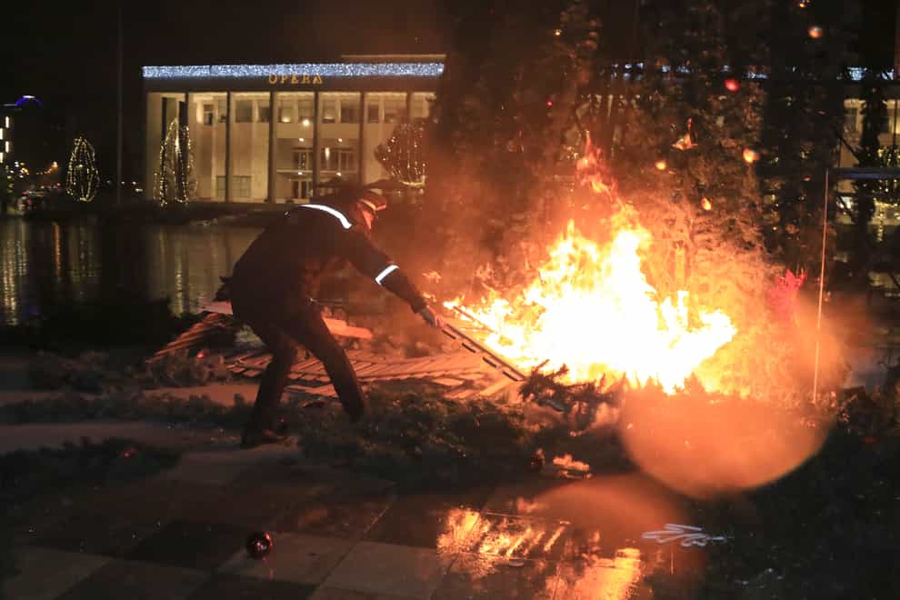 A Christmas tree on fire near the Prime’s Minister office during clashes in Tirana, Albania
