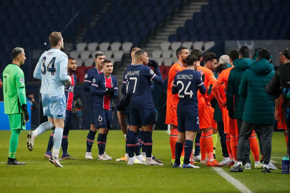 Players of Paris St Germain and Istanbul Basaksehir leave the pitch on Tuesday