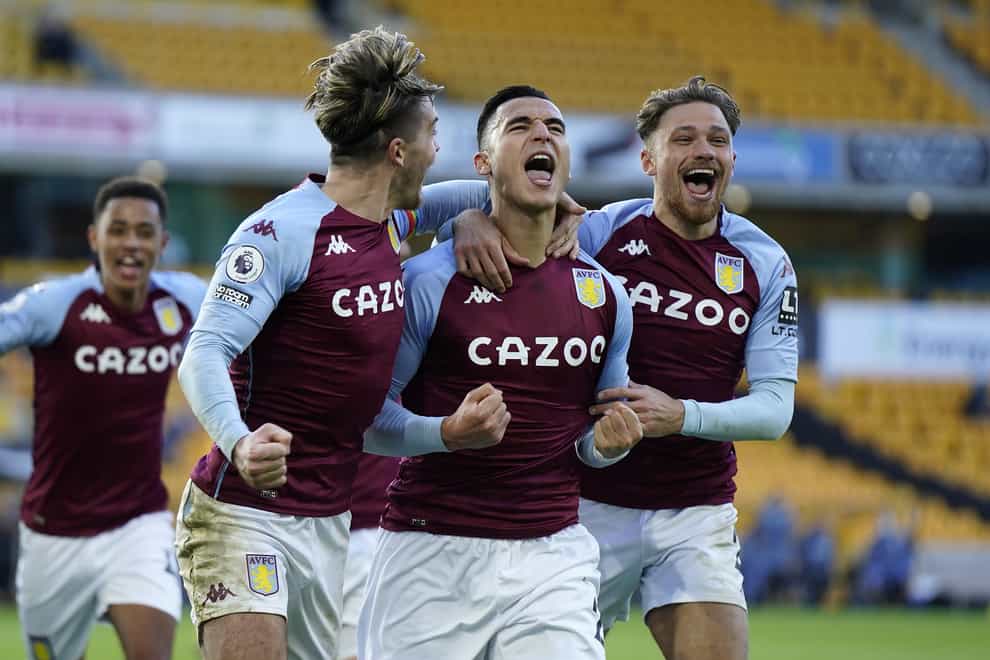Anwar El Ghazi (centre) celebrates his injury-time penalty winner for Aston Villa at Wolves with team-mates Jack Grealish (left) and Matty Cash (right)