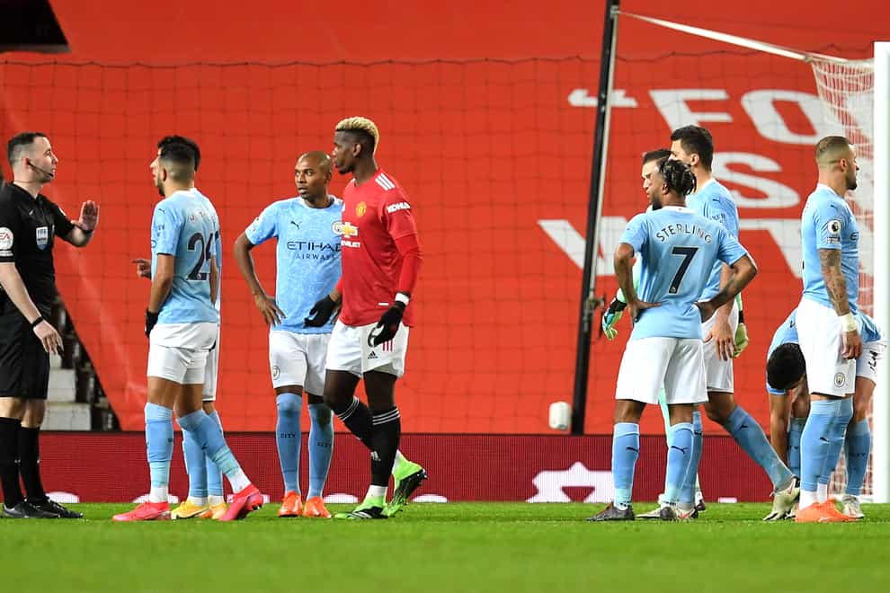 Manchester City's players remonstrate with referee Chris Kavanagh after he awarded a penalty to Manchester United. The decision was overturned on review because of an offside