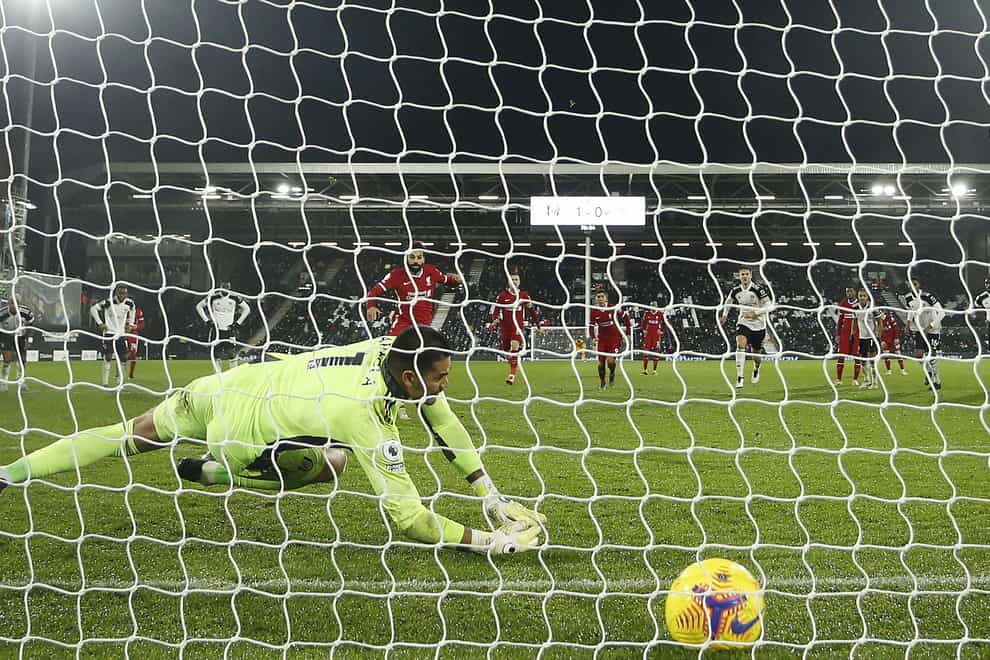 Liverpool’s Mohamed Salah scores from the spot at Craven Cottage
