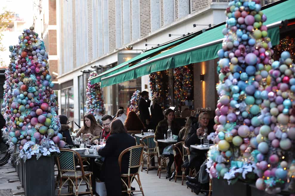 People dining on outdoor tables at a restaurant in Soho