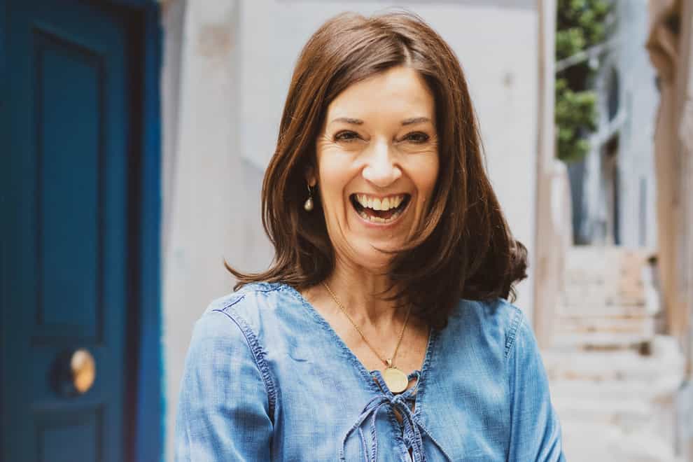 A portrait photo of author Victoria Hislop, smiling and looking happy