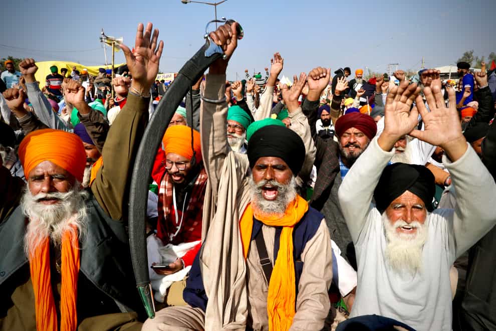 Protesting farmer leaders shout slogans as they sit on a day long hunger strike at the Delhi- Haryana border