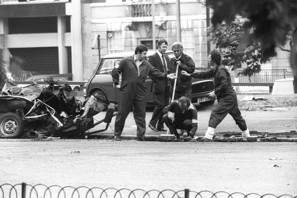 Police forensic officers working on the remains of the car which housed the Hyde Park car bomb in 1982