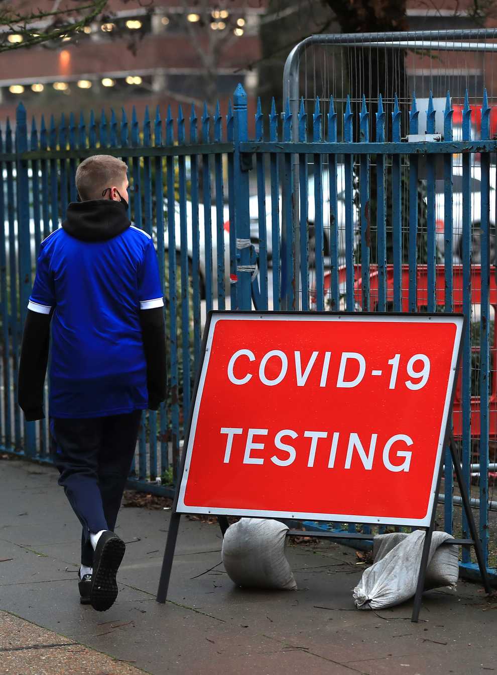 People walk past a Covid-19 testing sign