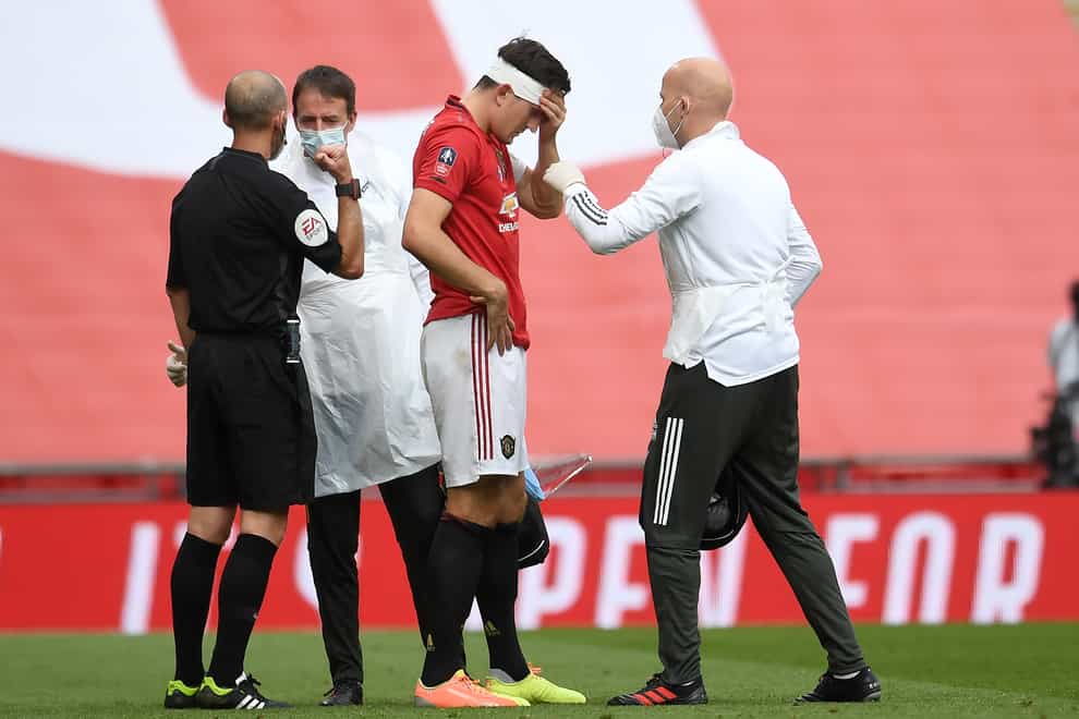 Manchester United defender Harry Maguire receives treatment for a head injury in the FA Cup semi-final against Chelsea at Wembley