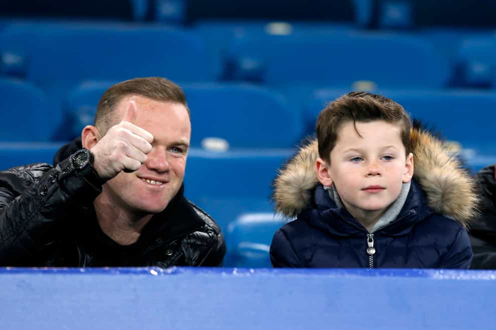 Wayne Rooney and his son Kai watching a football a game