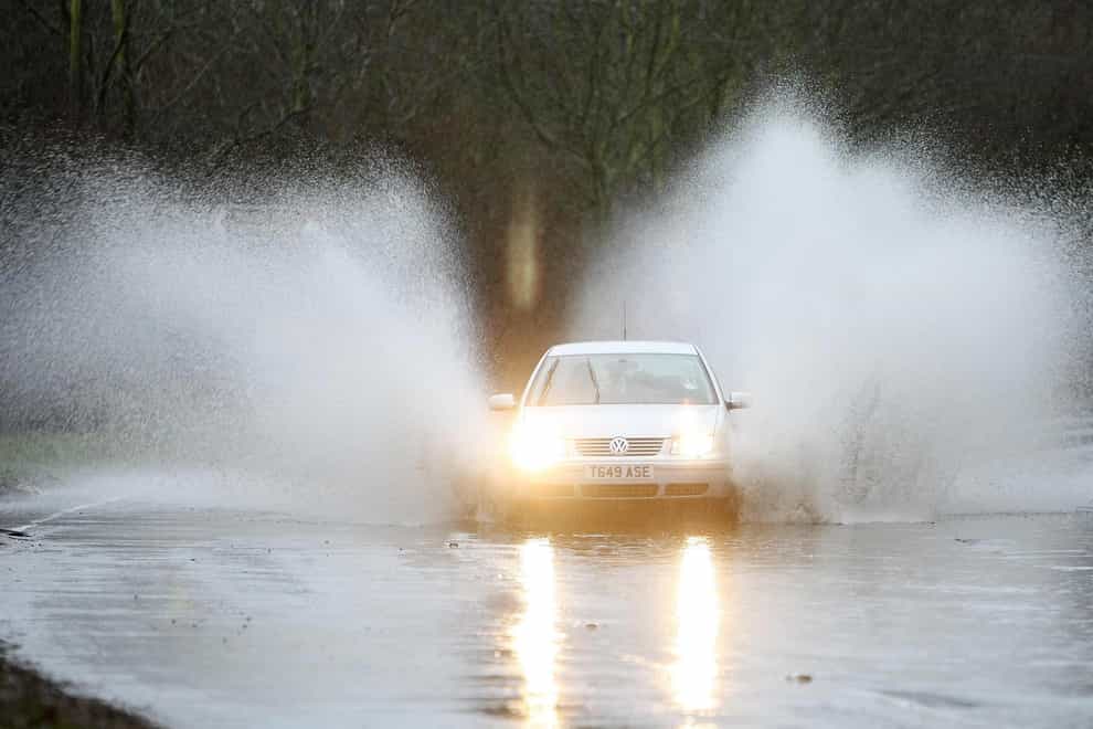 A car drives through floodwater
