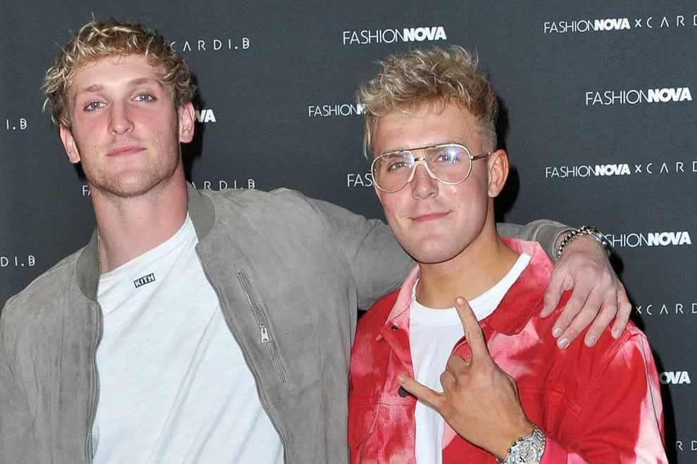 <p>Logan (left) and brother Jake (right) have both turned their hands to boxing in recent years</p>