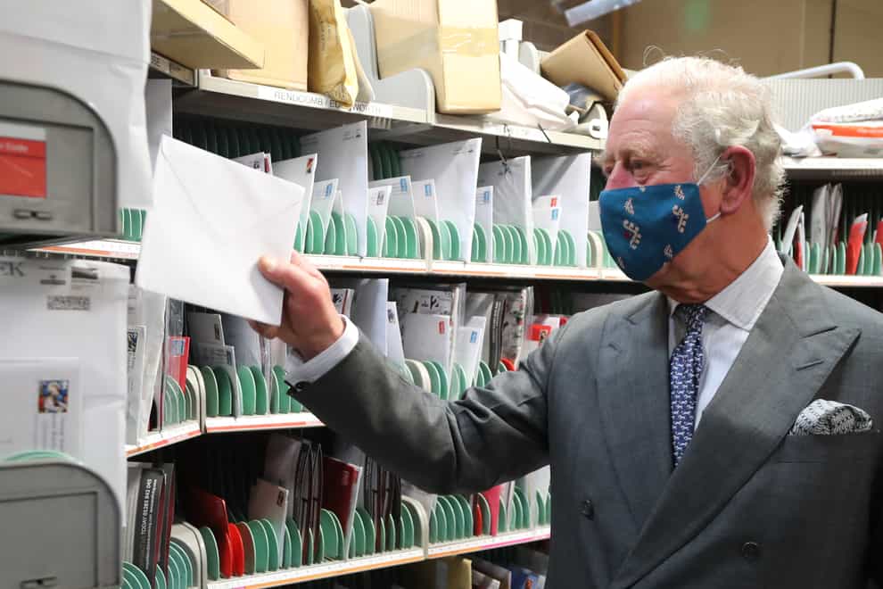 The Prince of Wales helps to sort letters during a visit to Royal Mail’s Delivery Office, in Cirencester, to recognise the vital public services that the country’s postal workers provide, especially this year and in the run-up to Christmas