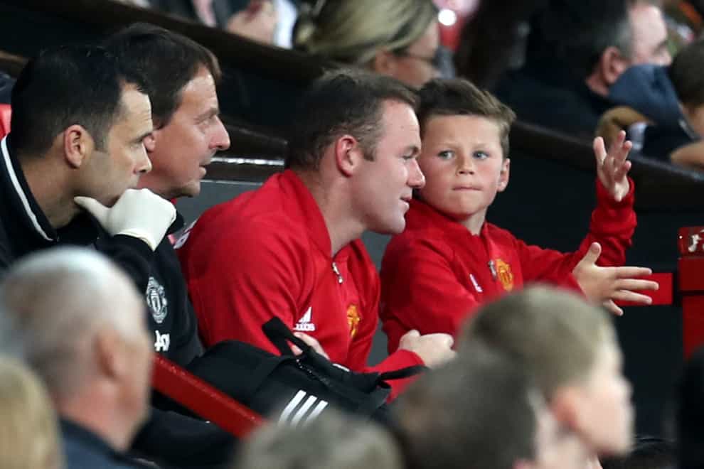 Wayne Rooney said he was a "proud dad" after his son signed for Manchester United