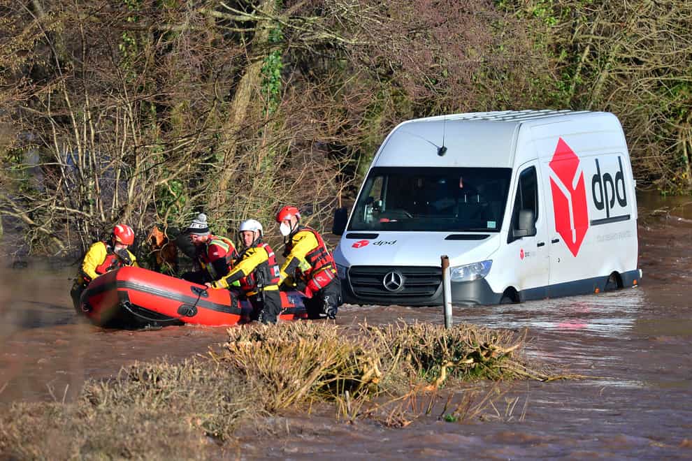 Emergency services rescue a DPD delivery van driver stranded in flood water in Newbridge on Usk, in Wales