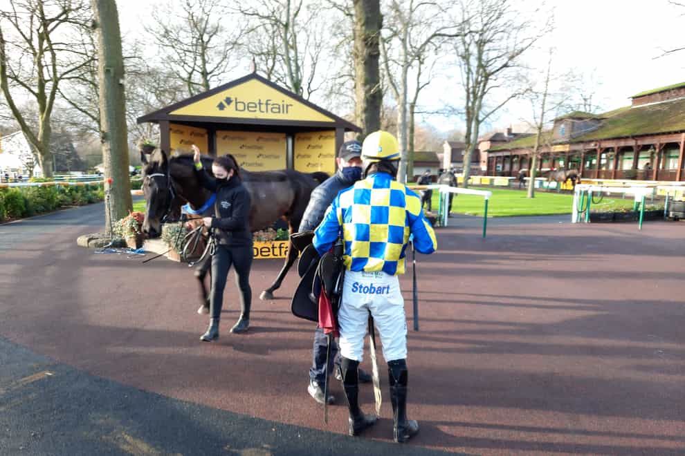 Assistant trainer Alan O'Keeffe with jockey Sean Quinlan and Cheddleton after his novice chase success at Haydock