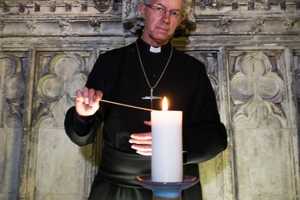 Archbishop of Canterbury Justin Welby lighting a candle