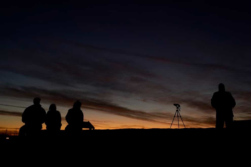 Stargazers watch the alignment of Saturn and Jupiter