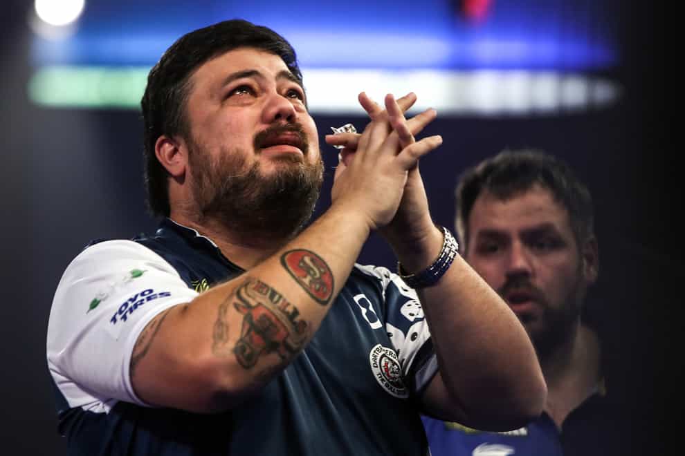 Danny Baggish (left) cries after beating Adrian Lewis (right) in the PDC World Darts Championship at Alexandra Palace