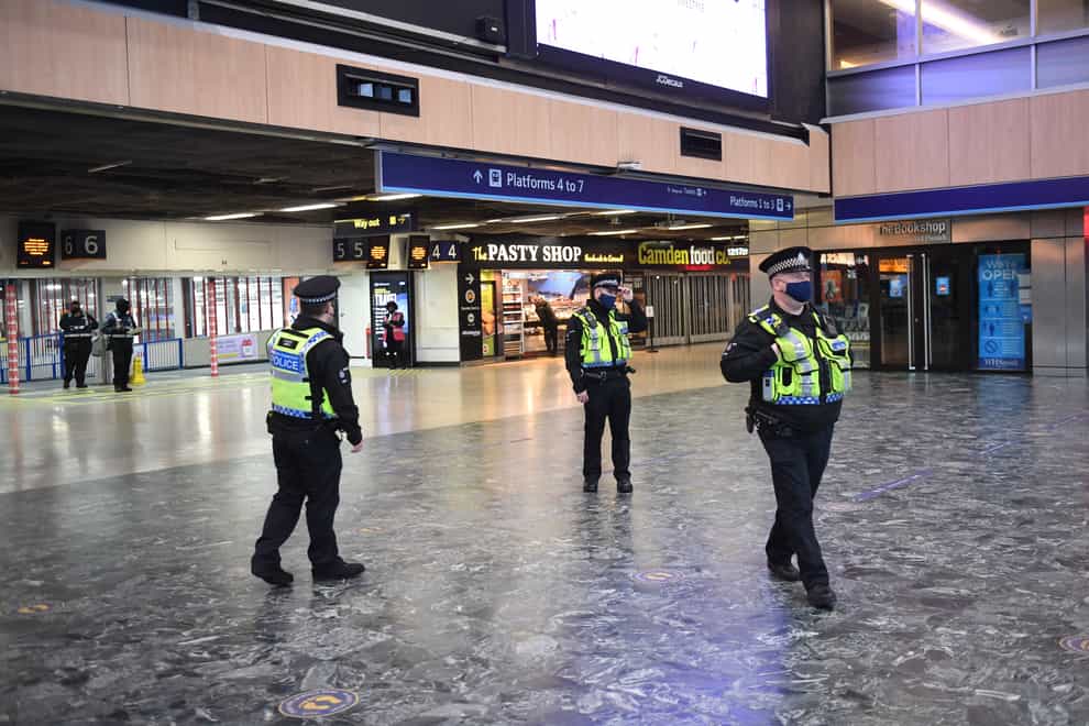 Police officers at Euston Station, London, with more being deployed to enforce travel rules at London’s stations (Stefan Rousseau/PA)