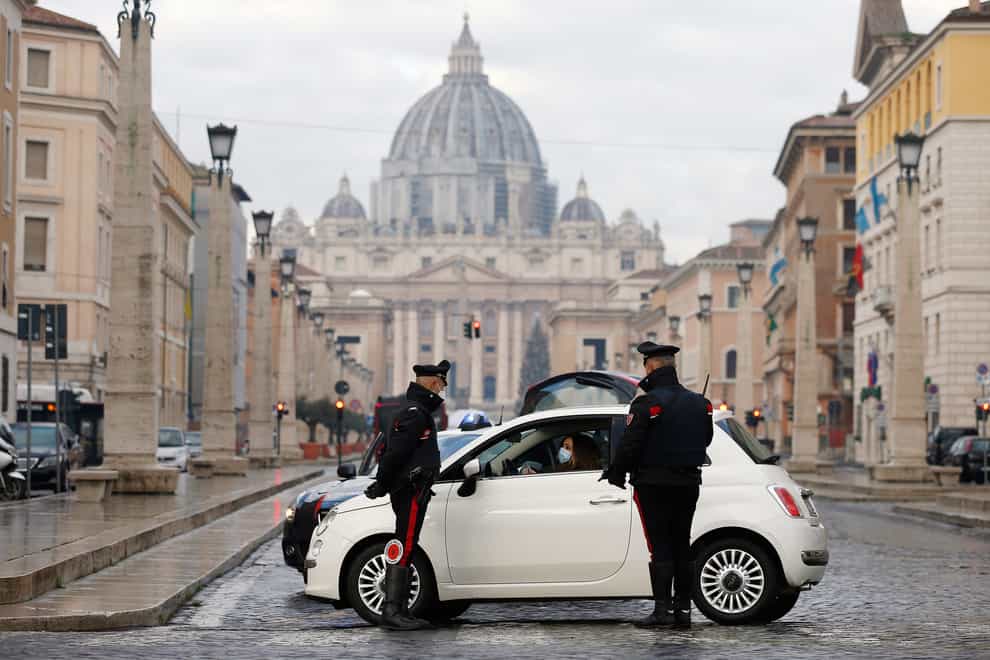 Italian carabinieri officers check vehicles in front of St Peter’s Basilica at the Vatican (Cecilia Fabiano/AP)