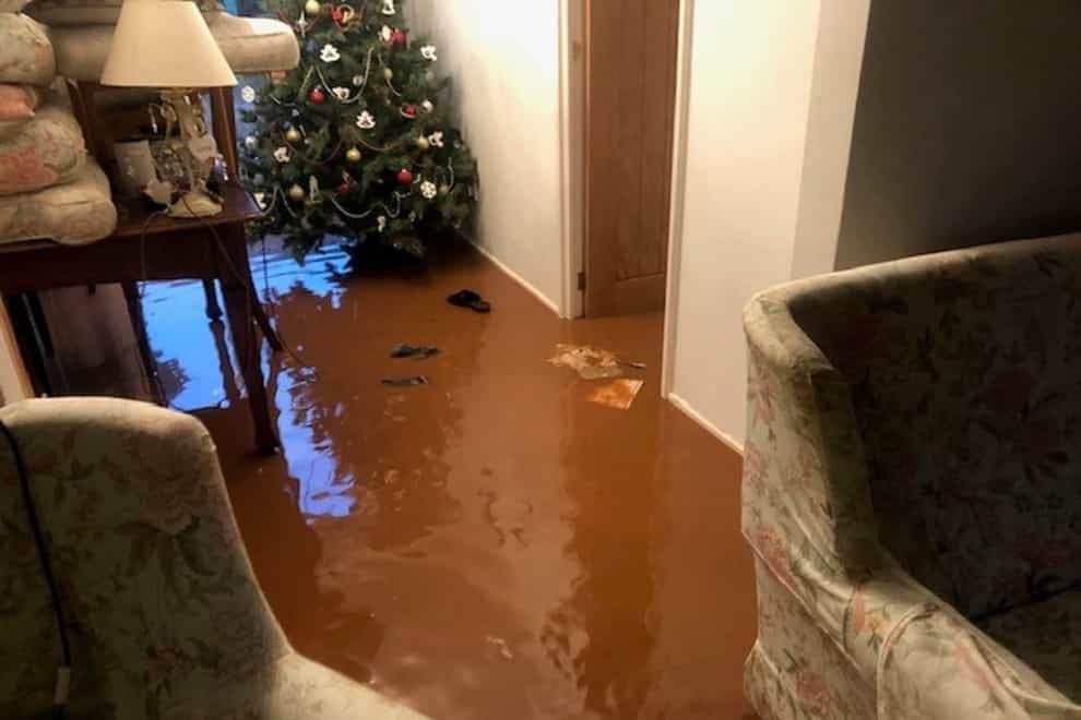 Flood water surrounds a Christmas tree at Helddwyn James home in Sully, south Wales
