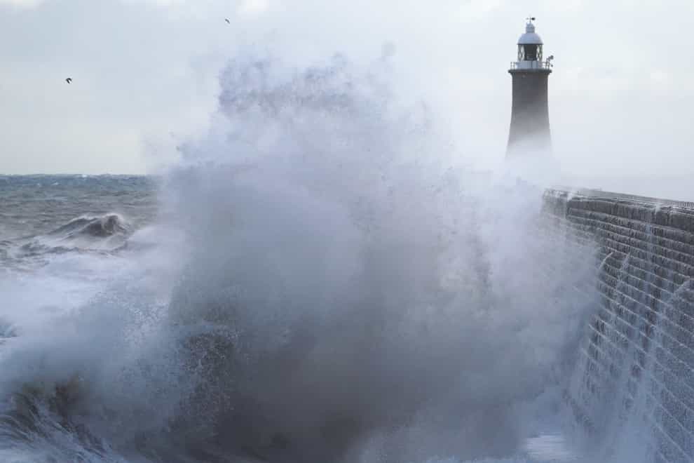 Waves crash against the pier wall at Tynemouth