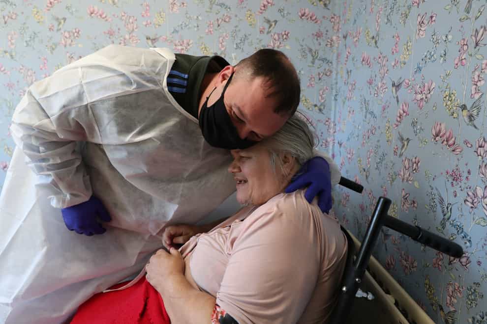 Man embraces his mother at a care home in Leeds on Christmas Day