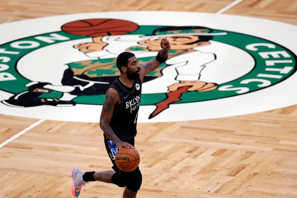 Brooklyn Nets’ Kyrie Irving brings the ball up during the first half of the team’s NBA basketball game against the Boston Celtics