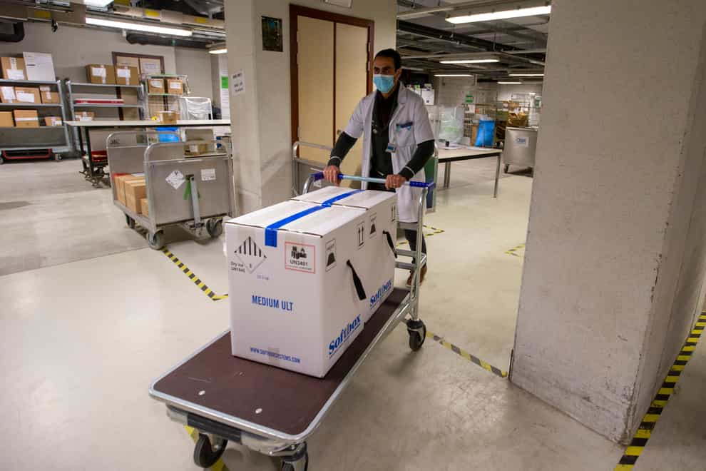 Medical staff receive part of a Pfizer/BioNTech Covid-19 vaccine shipment at the UZ Leuven hospital in Leuven, Belgium