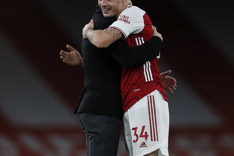 Granit Xhaka celebrates Arsenal's win over Chelsea with his manager
