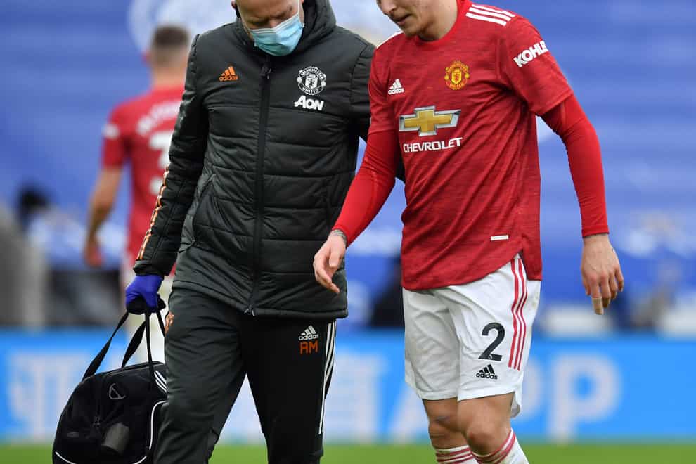 Victor Lindelof walks off the pitch with the physio