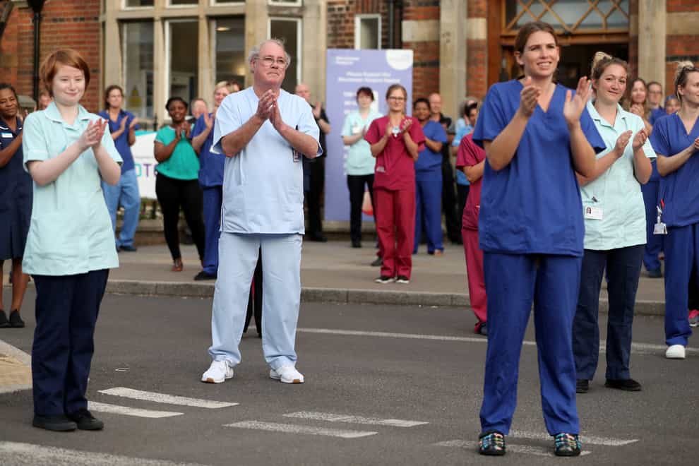 Hospital staff stand outside the Royal Hampshire County Hospital