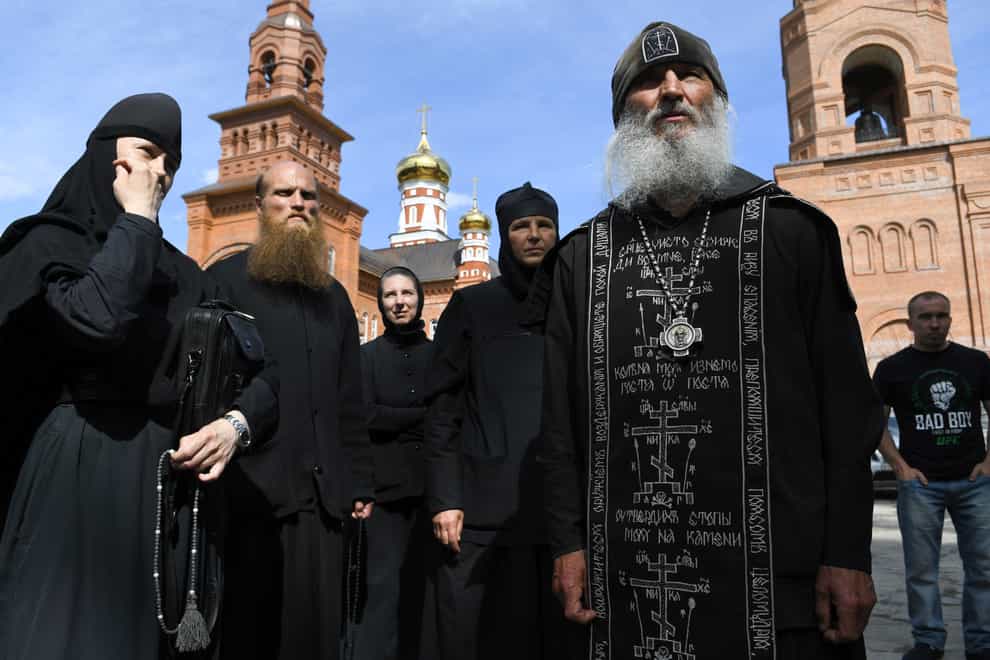Father Sergiy, right, a monk who has defied the Russian Orthodox Church’s leadership
