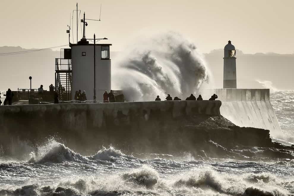 People watch as huge waves hit the sea wall in Porthcawl