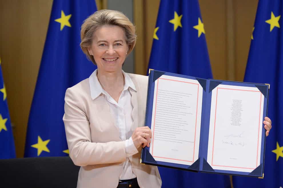 European Commission President Ursula von der Leyen shows the signed trade deal