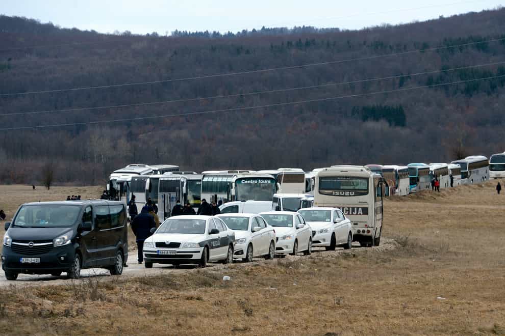 Migrants wait in buses to be relocated from the Lipa camp in north-western Bosnia, near the border with Croatia
