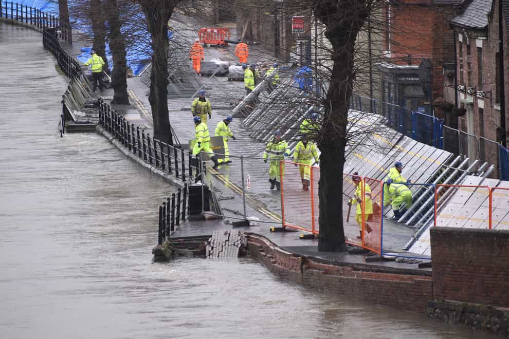 Environment Agency teams work on temporary flood barriers in the Wharfage area of Ironbridge, Shropshire, after floodwaters receded following an emergency evacuation of some properties earlier this week (Matthew Cooper/PA)