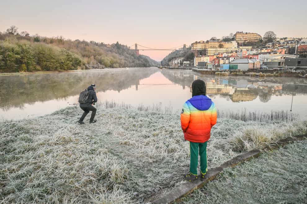 People admire the view over the Avon Gorge and Clifton Suspension Bridge on a frosty morning in Bristol