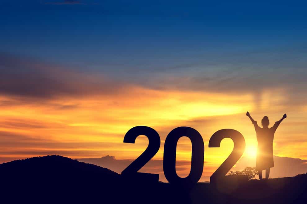 Silhouette of a woman celebrating start of 2021