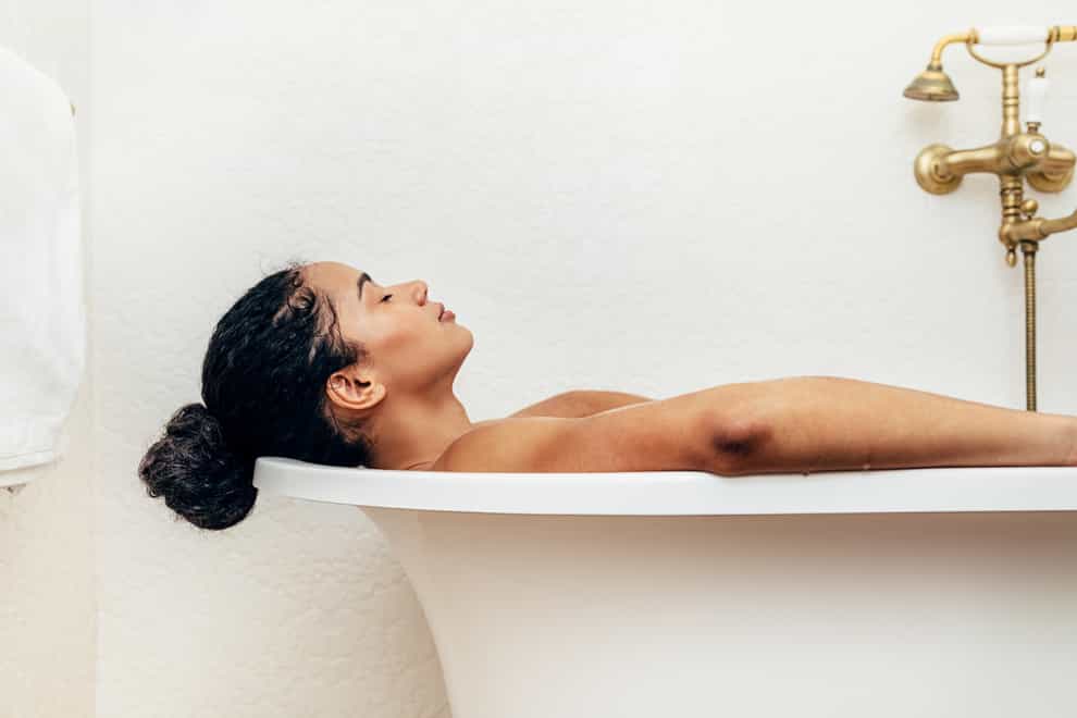 Side view of young woman having a bath