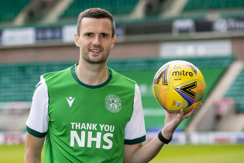 Jamie Murphy poses with a football