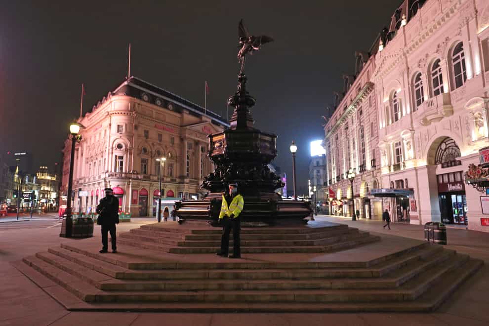 Police at the statue of Eros in Piccadilly Circus in London