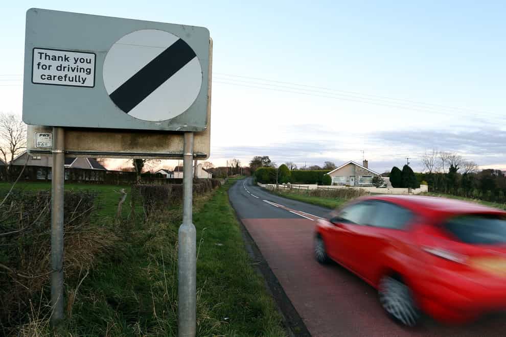 A car drives past a sign saying Thank you for driving carefully